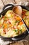 Tatws Pum MunudÂ is a traditional potato and bacon dish close-up in a pan. Vertical